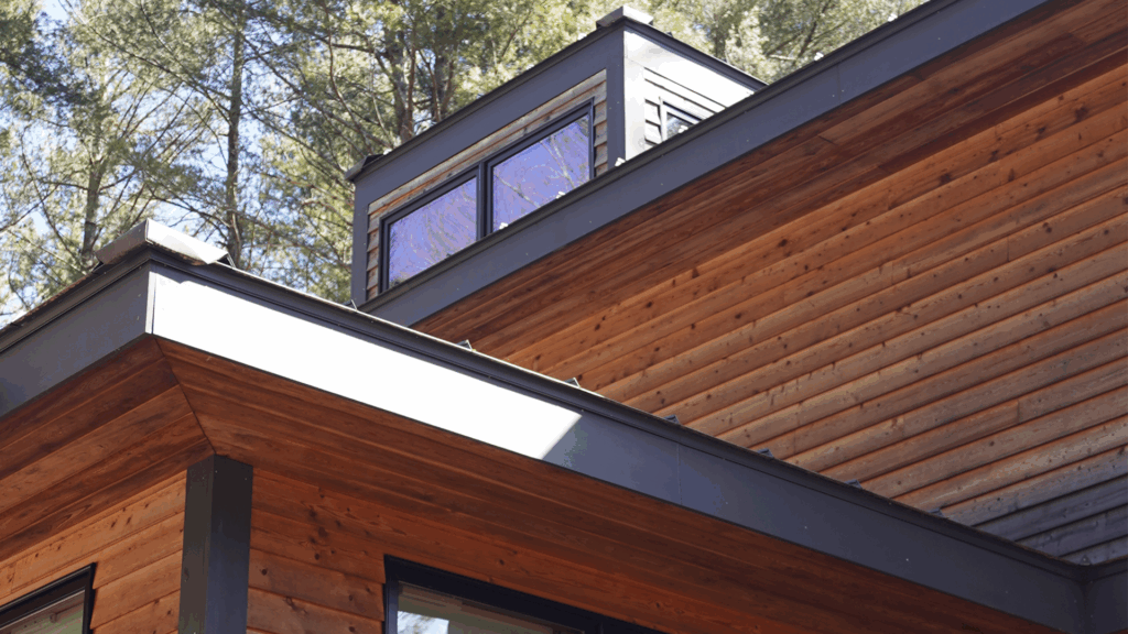 Exterior detail shot of the roof intersections and upper windows.