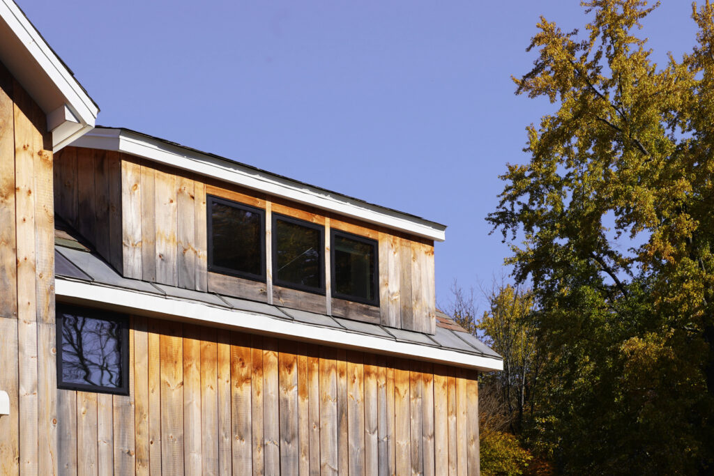 Upwards shot of the windows and aged wood siding.