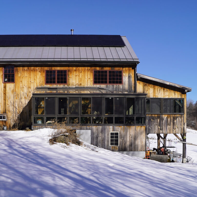 Exterior shot, side profile of house and attached sunroom.