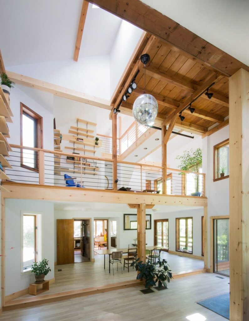 Interior shot of millwork, structural elements, and flow of the space highlighting the open, railed second level.